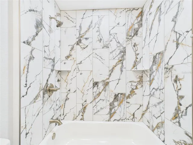 an empty room with a ceiling fan and a window