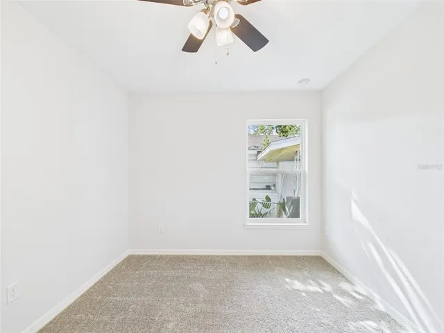 wooden floor in an empty room with a kitchen