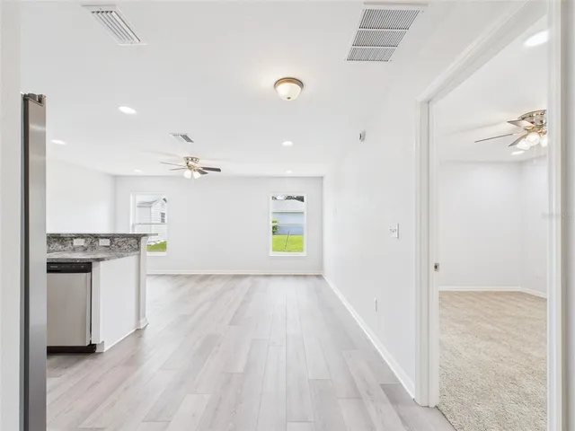an empty room with closet and windows
