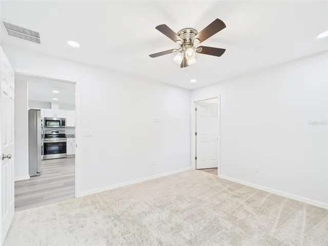 a bathroom with a granite countertop sink mirror vanity and toilet