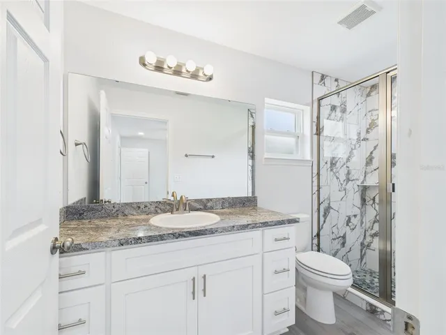 a view of storage and utility room with a window