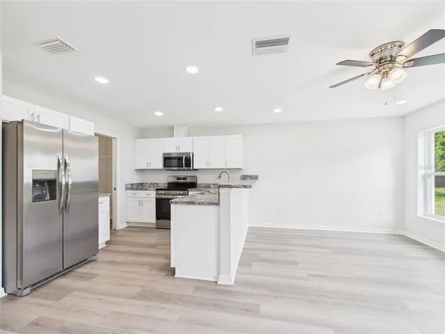 a kitchen with a refrigerator and a sink