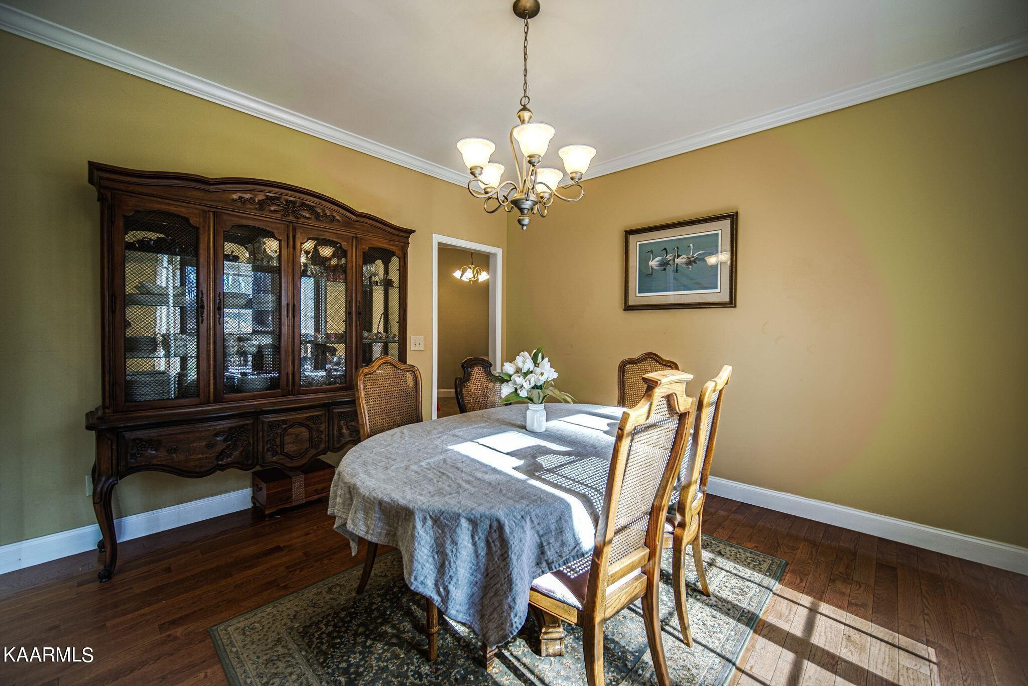 469 E Cove Monterey, TN 38574 - Photo 13 of 34 a view of a dining room with furniture a chandelier and wooden floor