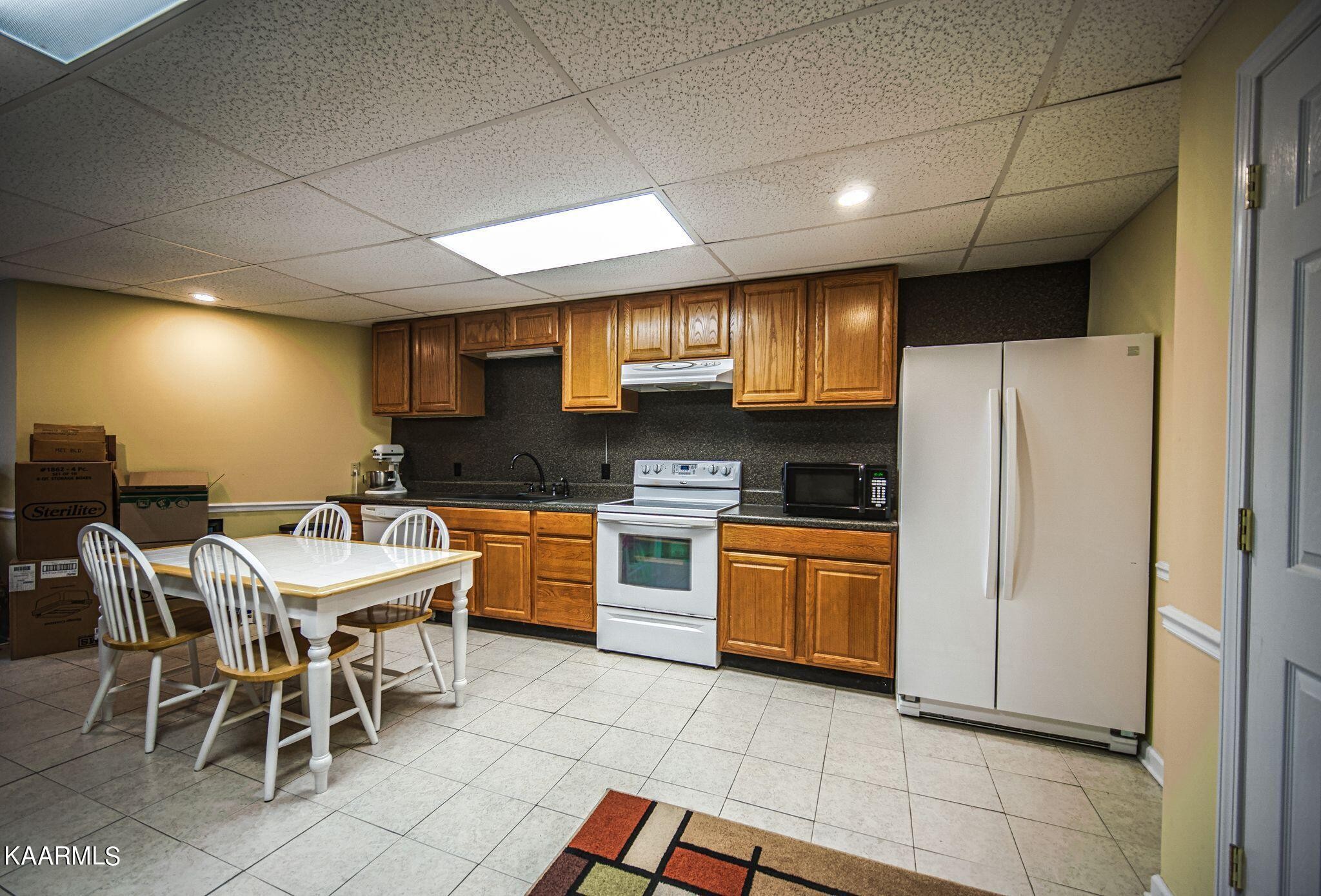 469 E Cove Monterey, TN 38574 - Photo 26 of 34 a kitchen with stainless steel appliances granite countertop a stove a sink a refrigerator with a dining table and chairs