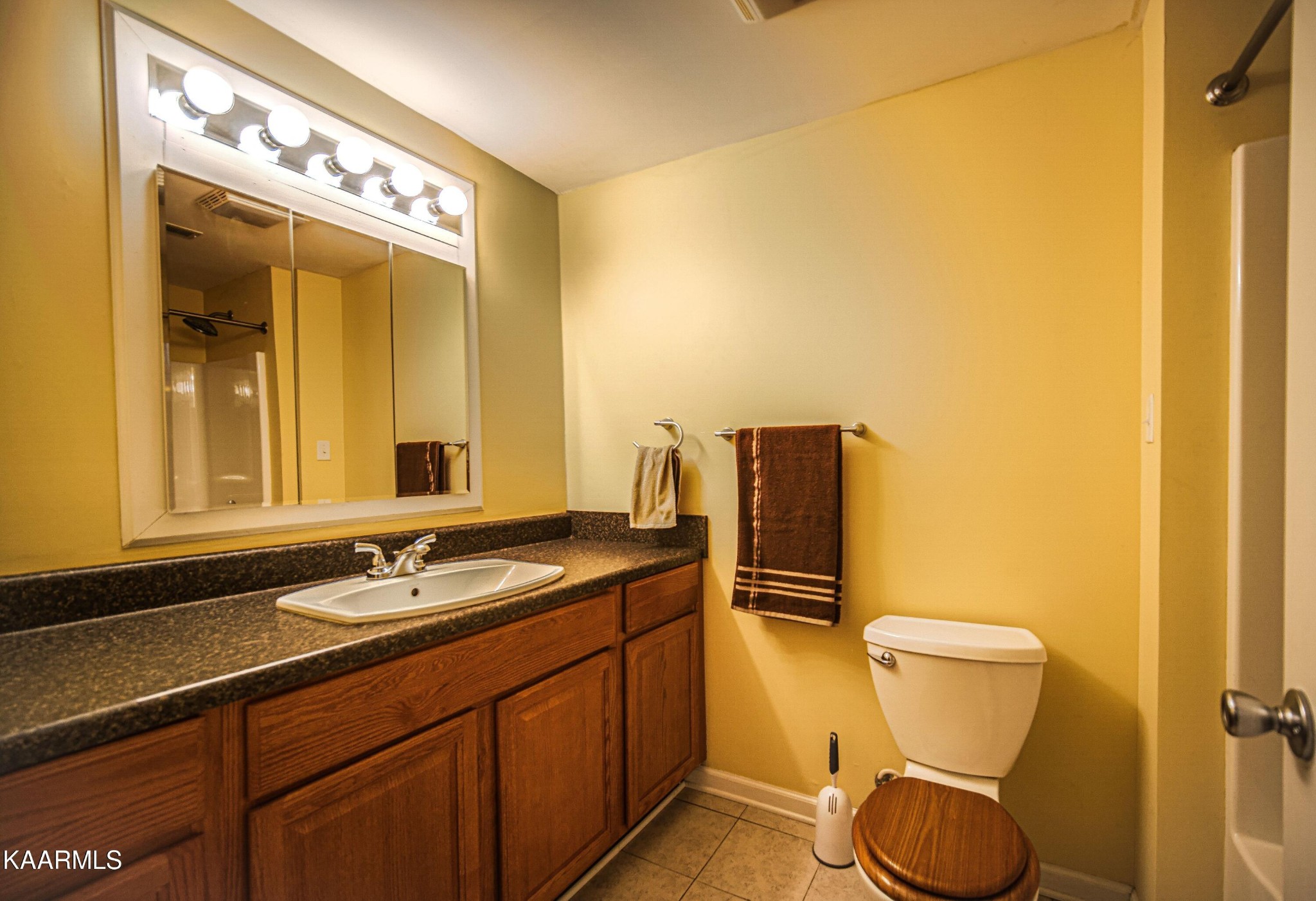 469 E Cove Monterey, TN 38574 - Photo 29 of 34 a bathroom with a granite countertop sink toilet and mirror