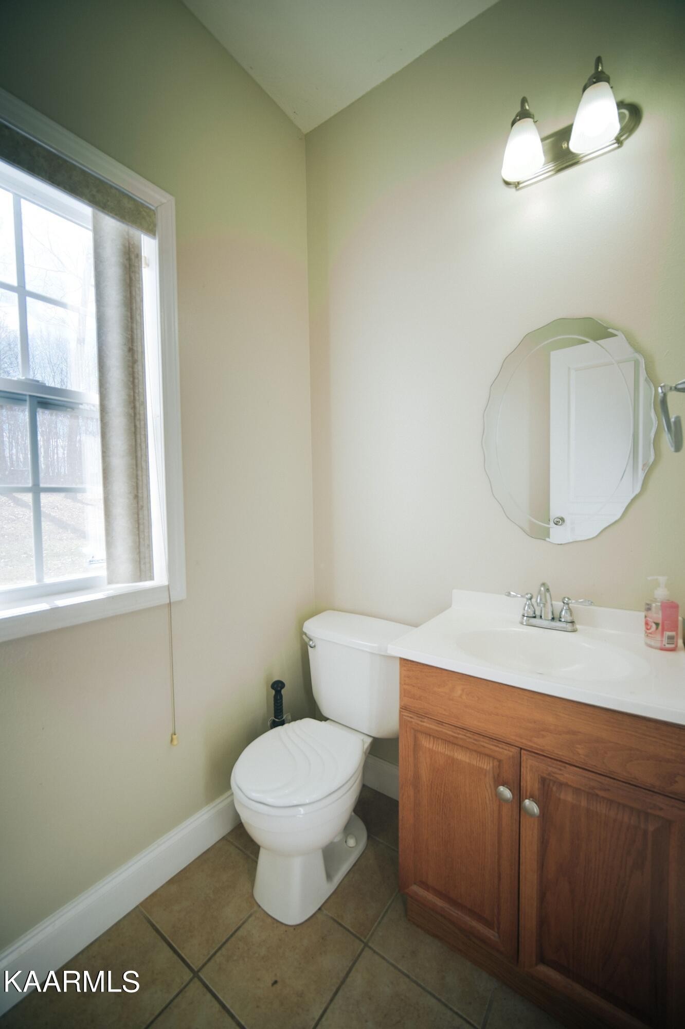469 E Cove Monterey, TN 38574 - Photo 30 of 34 a bathroom with a toilet sink and mirror