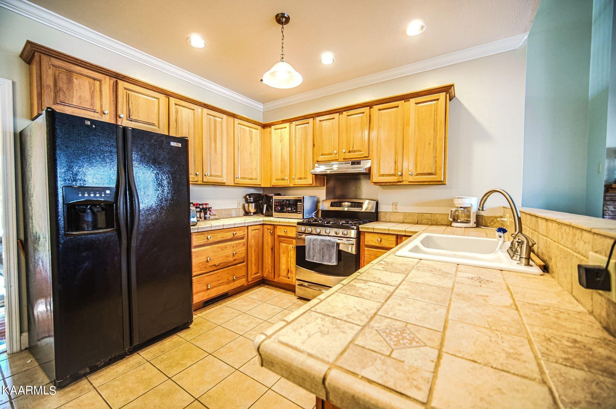 469 E Cove Monterey, TN 38574 - Photo 9 of 34 a kitchen with stainless steel appliances granite countertop a refrigerator and a stove top oven