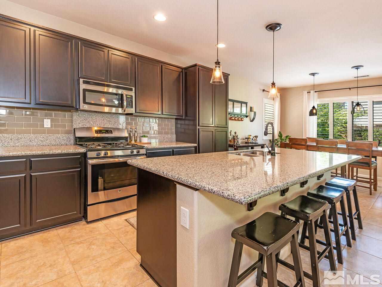 1985 Hope Valley Drive Reno, NV 89521 - Photo 4 of 19 a kitchen with stainless steel appliances granite countertop a sink a stove and a refrigerator