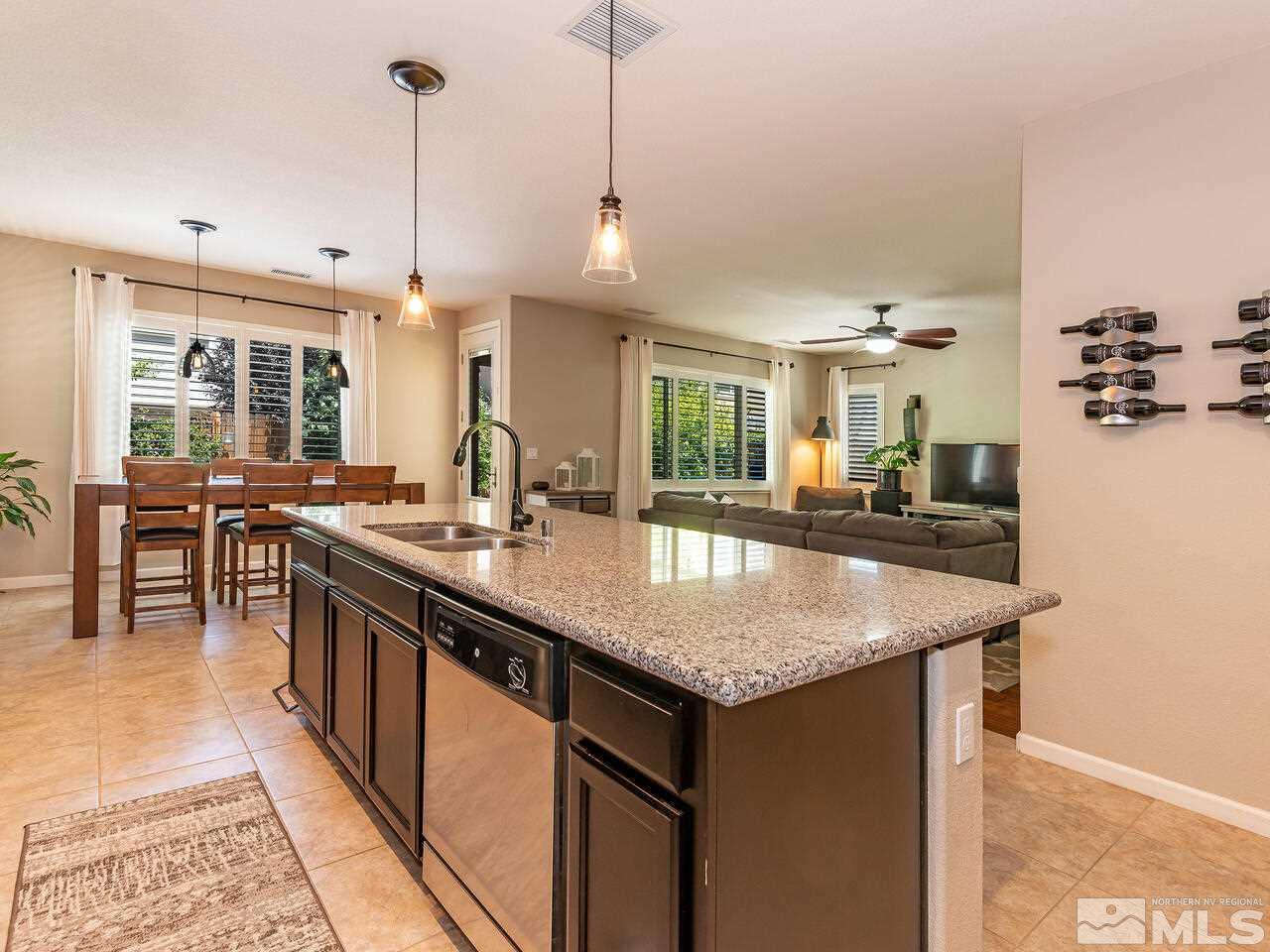 1985 Hope Valley Drive Reno, NV 89521 - Photo 5 of 19 a kitchen with stainless steel appliances granite countertop a sink a stove and a wooden floor