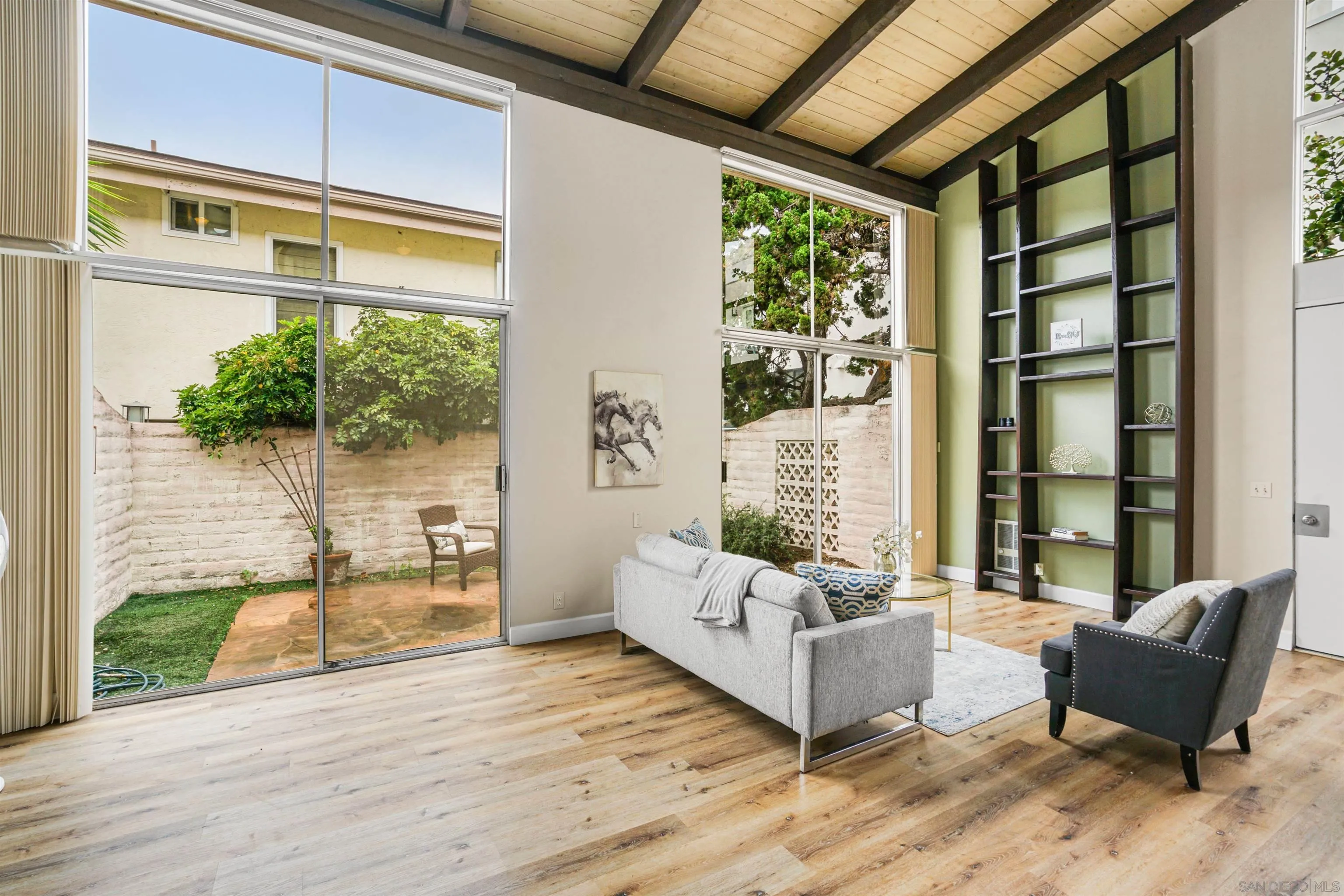 2544 Navarra Drive, Unit 5 Carlsbad, CA 92009 - Photo 1 of 39 a living room with furniture and a potted plant