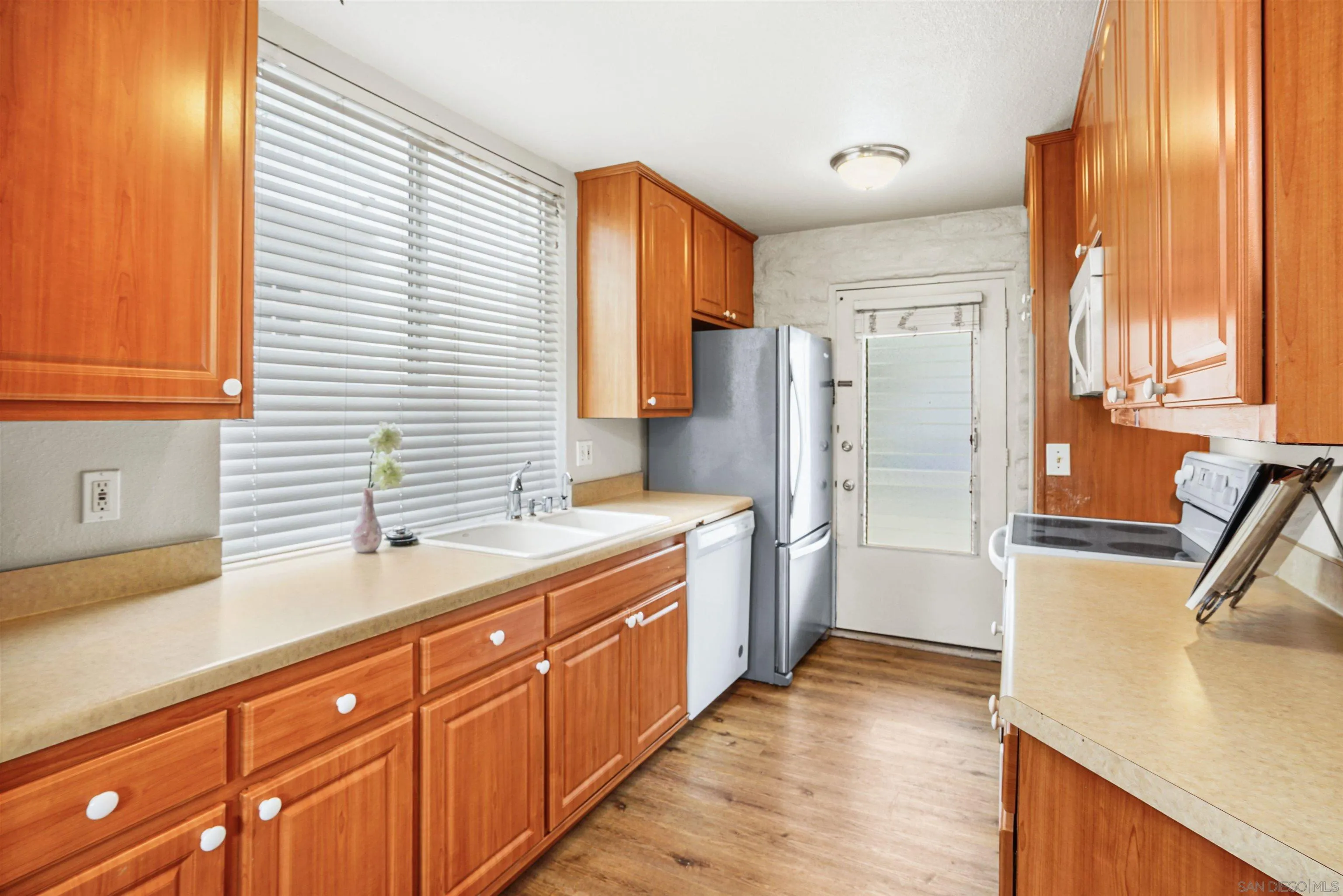 2544 Navarra Drive, Unit 5 Carlsbad, CA 92009 - Photo 15 of 39 a large kitchen with a sink and refrigerator