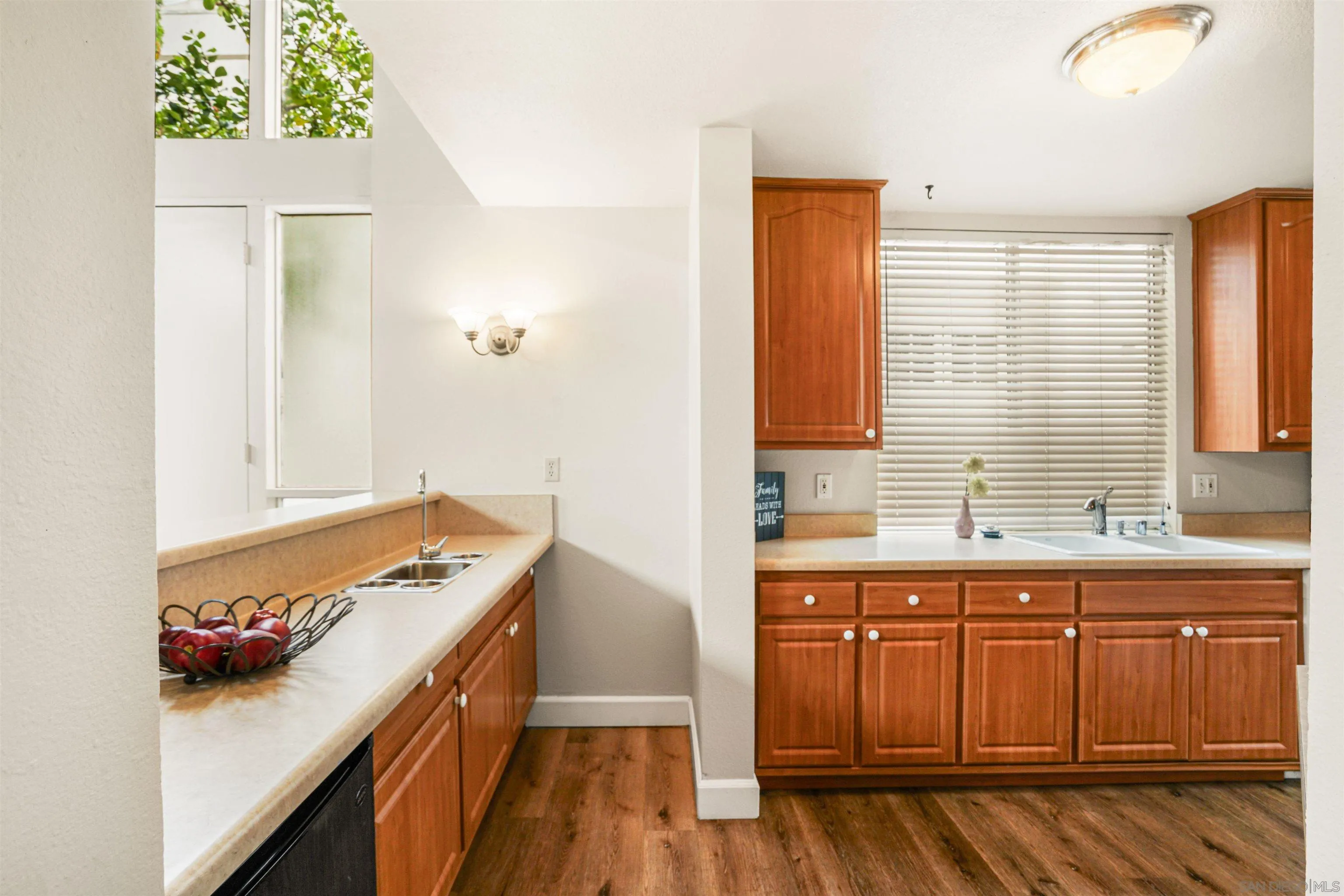 2544 Navarra Drive, Unit 5 Carlsbad, CA 92009 - Photo 16 of 39 a kitchen with a sink and wooden cabinets