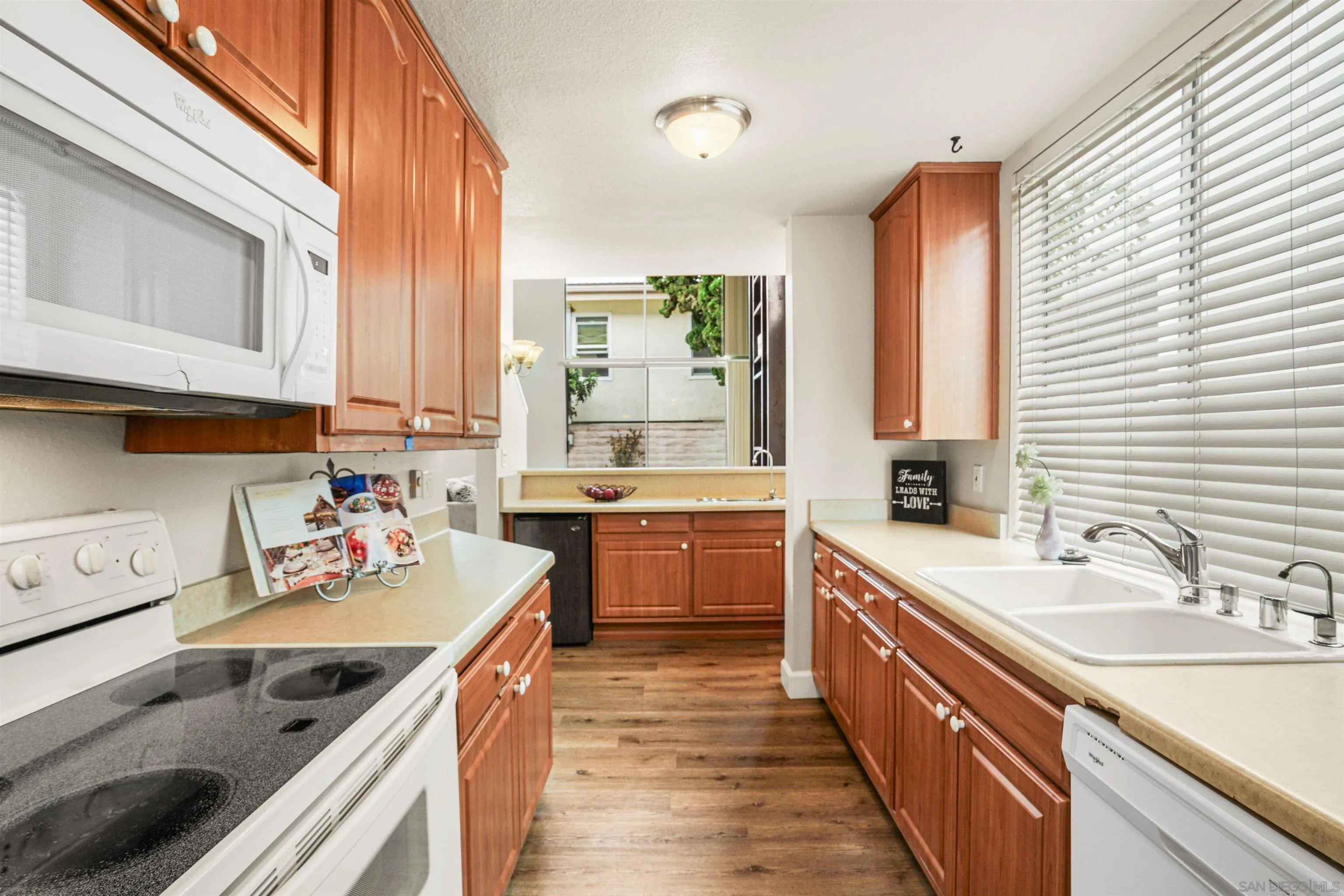 2544 Navarra Drive, Unit 5 Carlsbad, CA 92009 - Photo 17 of 39 a kitchen with stainless steel appliances granite countertop a sink stove and cabinets