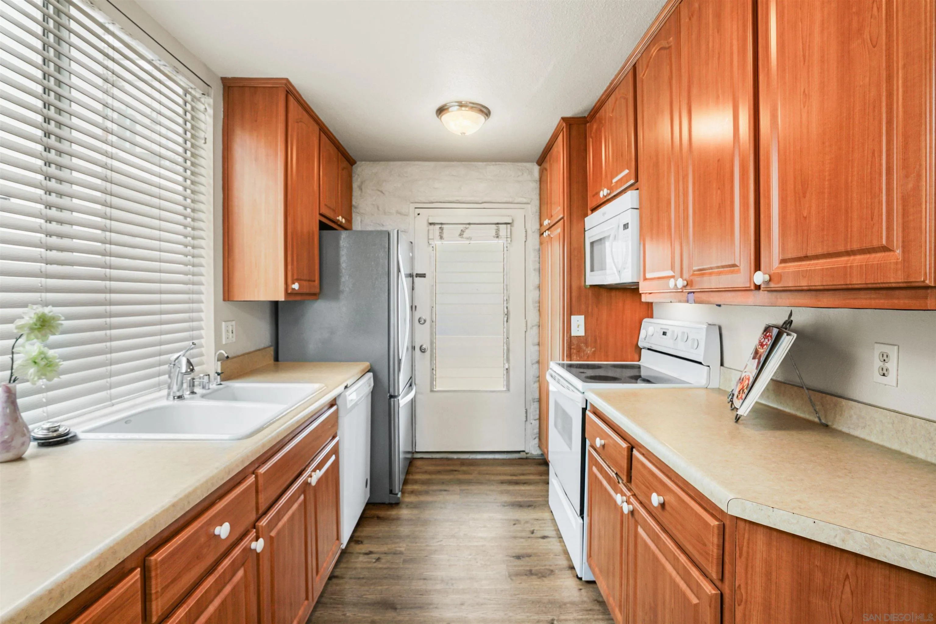 2544 Navarra Drive, Unit 5 Carlsbad, CA 92009 - Photo 18 of 39 a kitchen with a sink stove and refrigerator