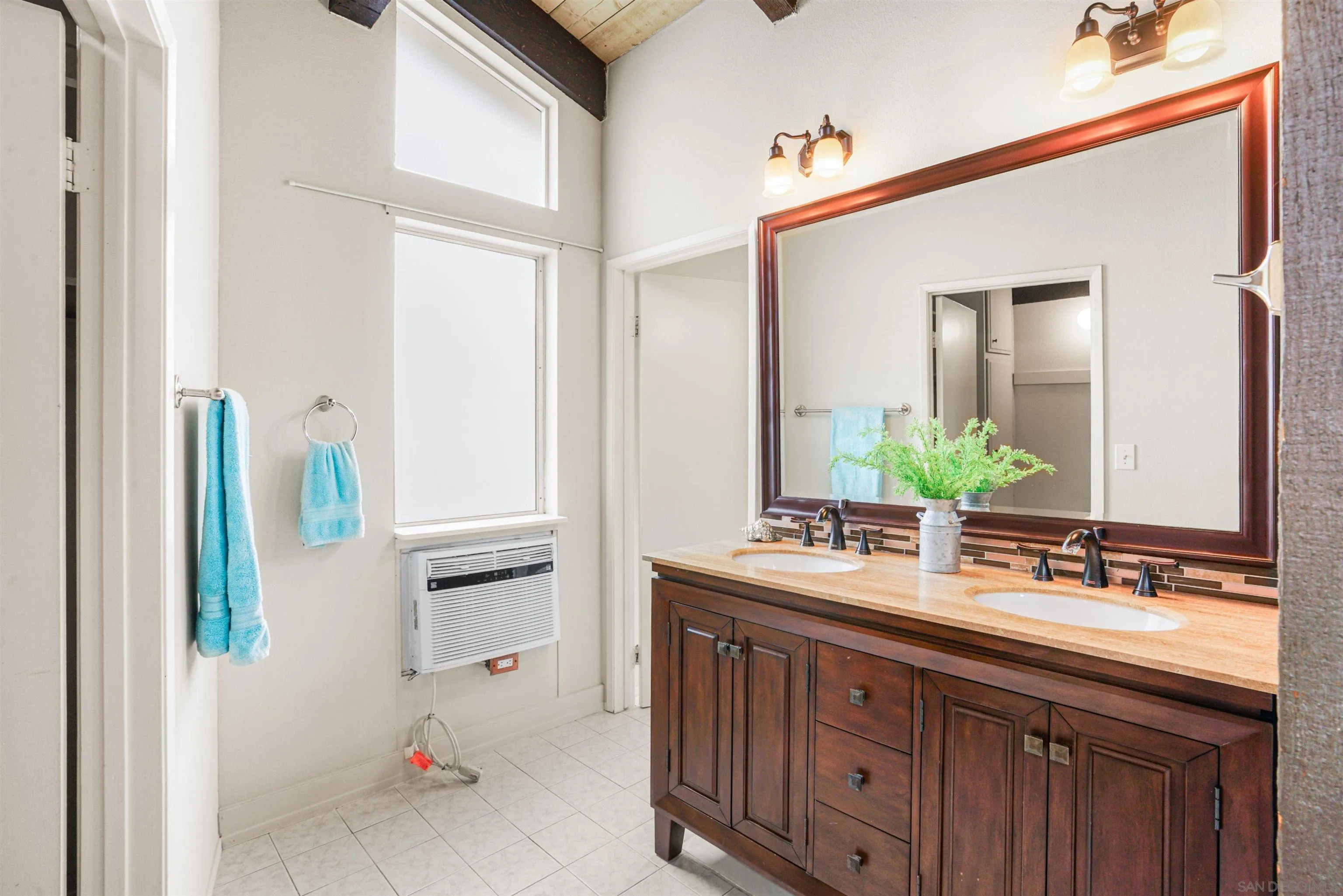 2544 Navarra Drive, Unit 5 Carlsbad, CA 92009 - Photo 28 of 39 a bathroom with a sink double vanity and a mirror