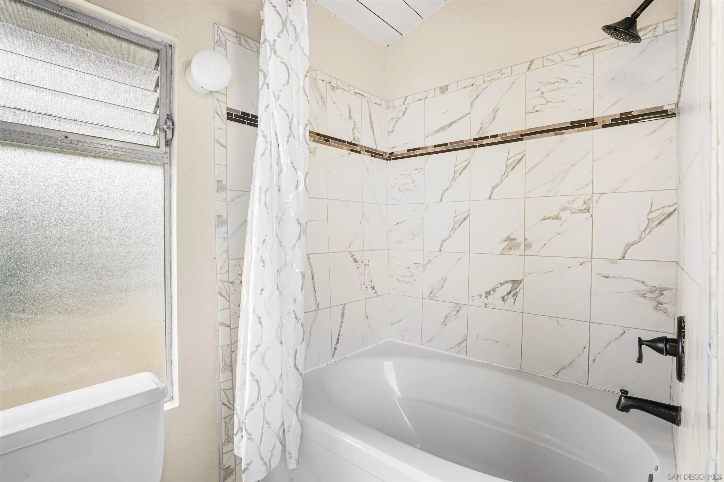 2544 Navarra Drive, Unit 5 Carlsbad, CA 92009 - Photo 29 of 39 a bathroom with a bathtub and a shower