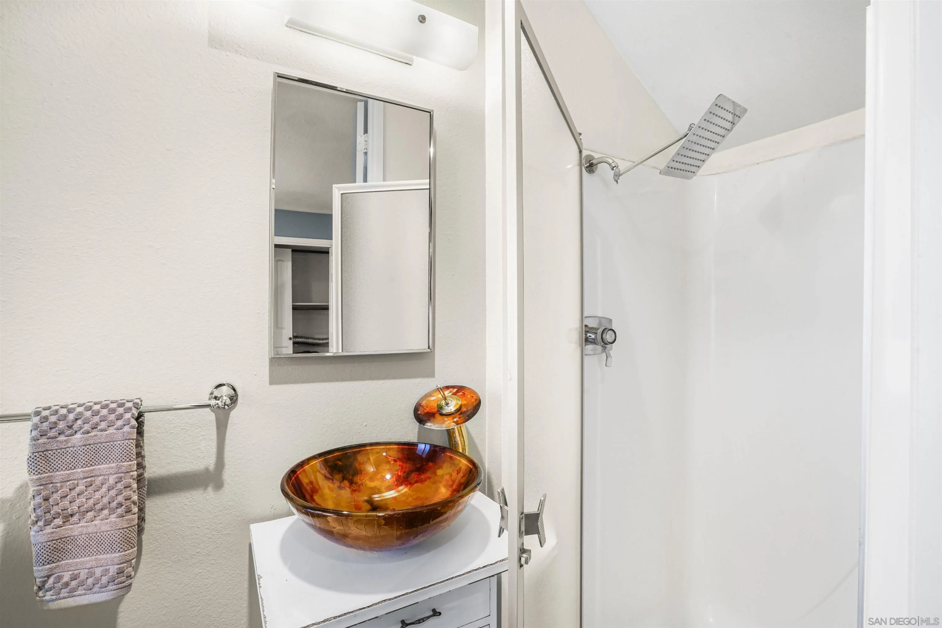 2544 Navarra Drive, Unit 5 Carlsbad, CA 92009 - Photo 32 of 39 a bathroom with a sink and a mirror