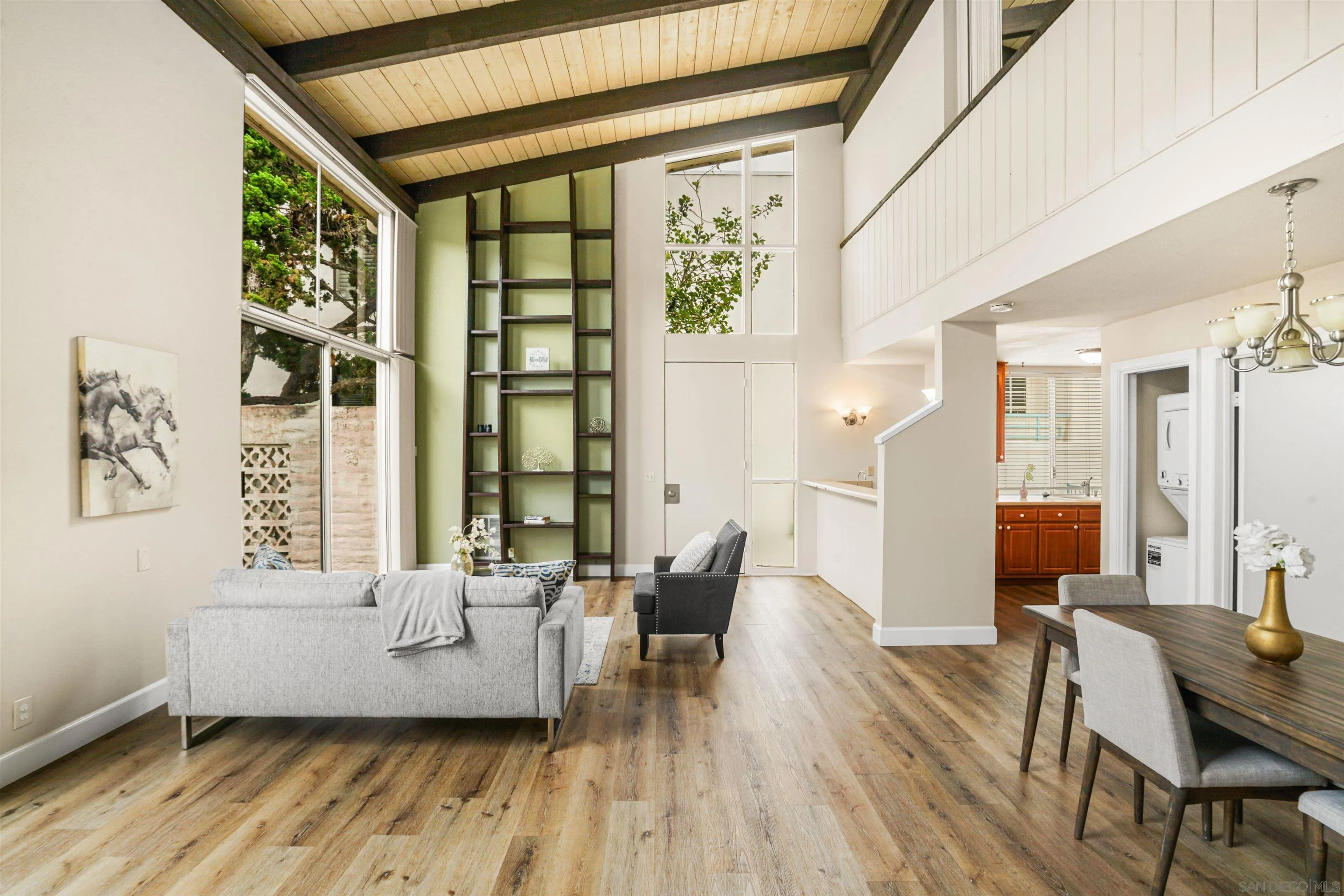 2544 Navarra Drive, Unit 5 Carlsbad, CA 92009 - Photo 5 of 39 a living room with furniture and large windows