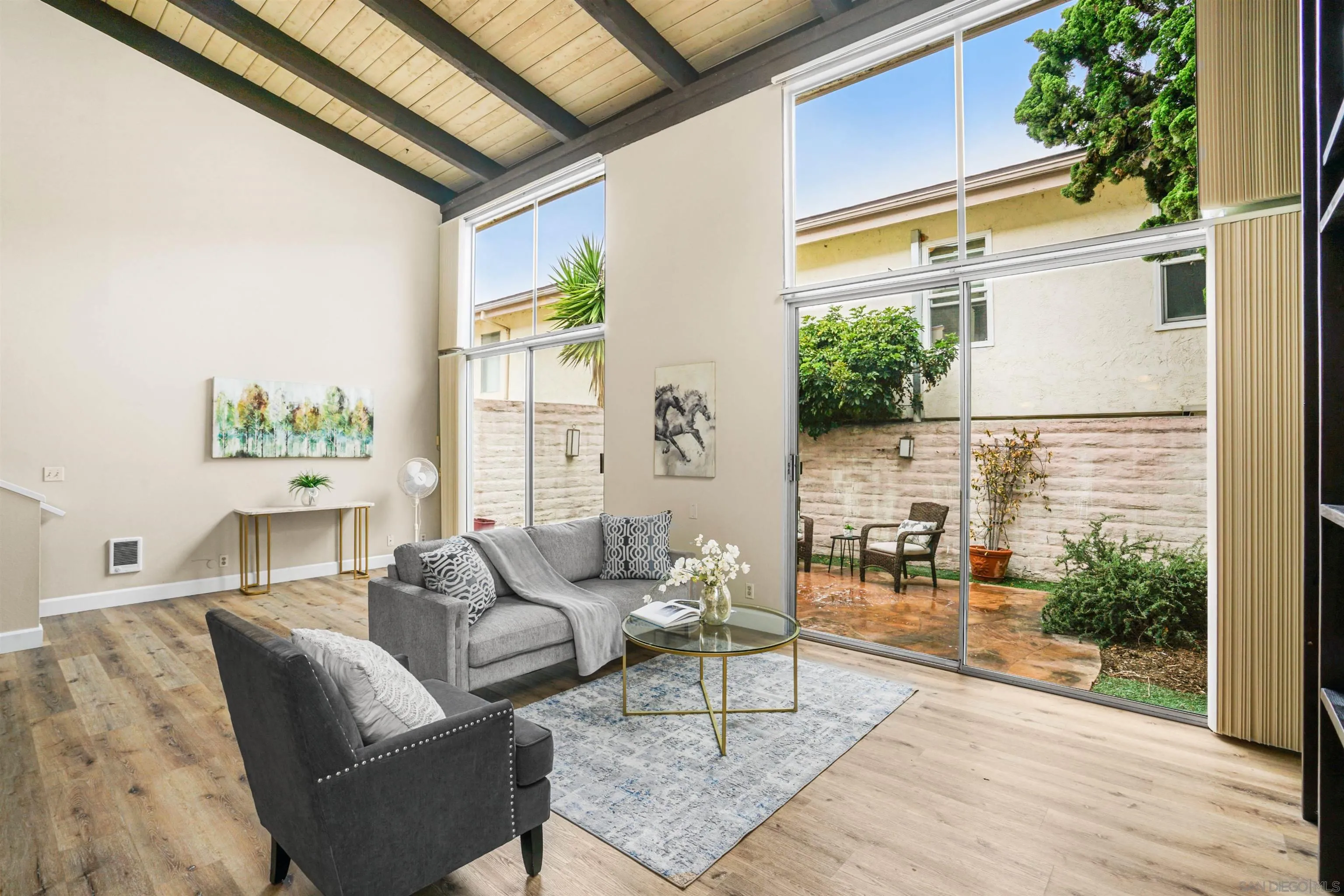 2544 Navarra Drive, Unit 5 Carlsbad, CA 92009 - Photo 7 of 39 a living room with furniture and a large window