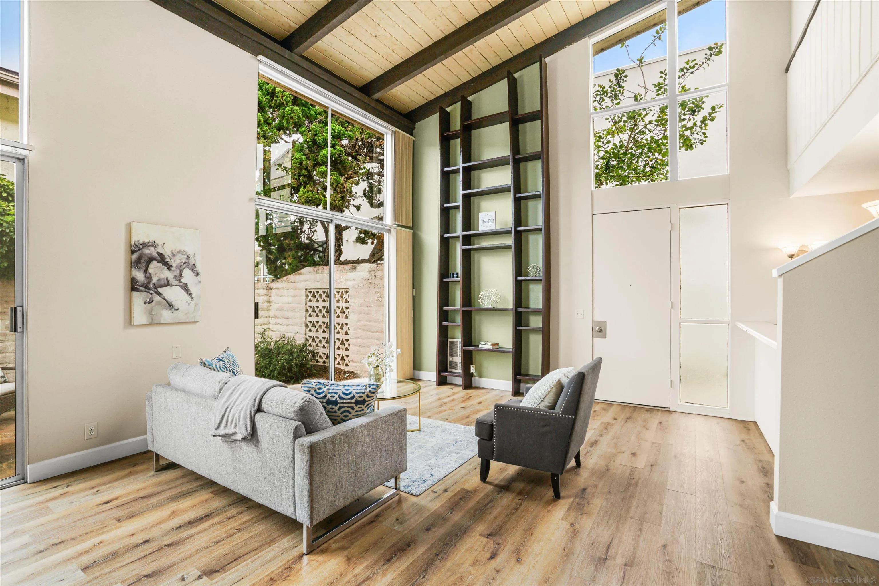 2544 Navarra Drive, Unit 5 Carlsbad, CA 92009 - Photo 8 of 39 a living room with furniture and a large window