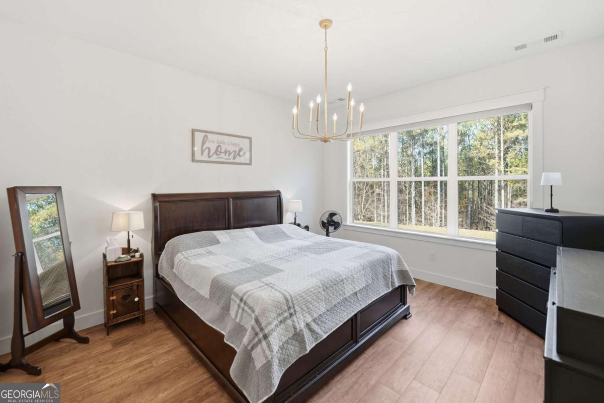 1950 Damascus Road Ball Ground, GA 30107 - Photo 11 of 29 a bedroom with a bed and a window