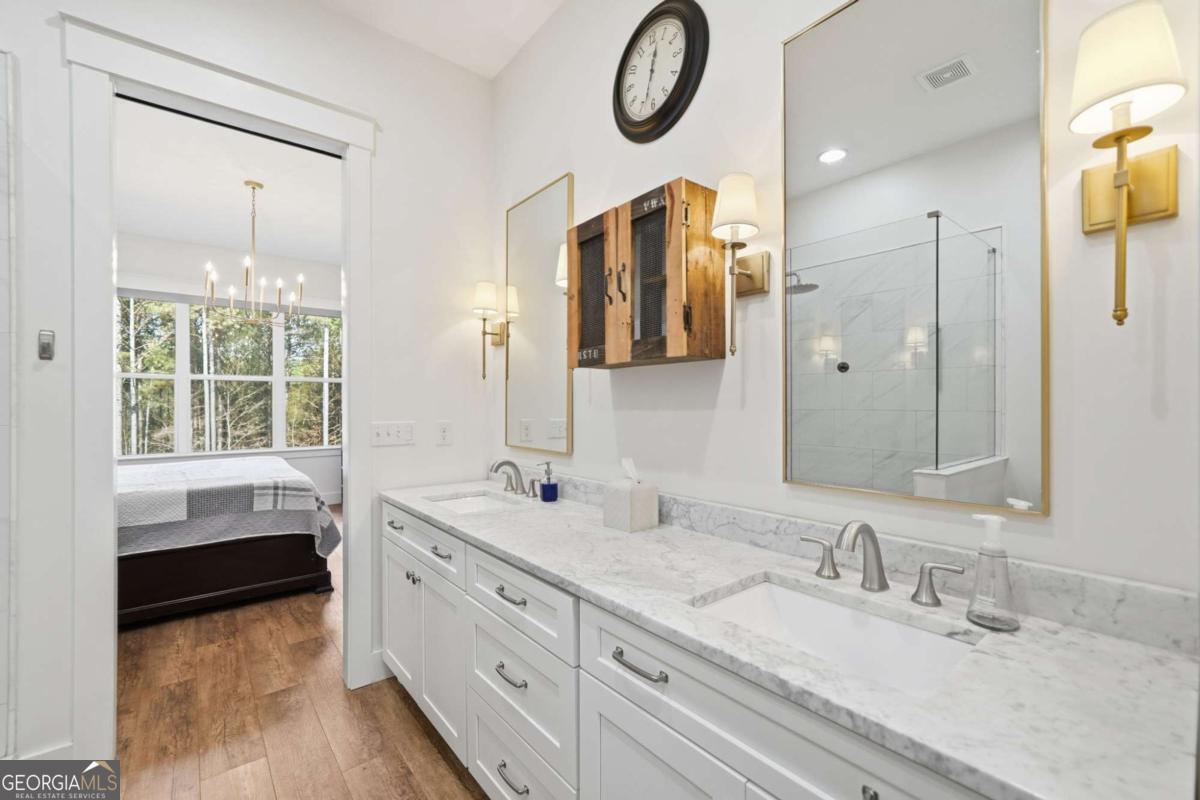1950 Damascus Road Ball Ground, GA 30107 - Photo 13 of 29 a bathroom with a double vanity sink and a mirror