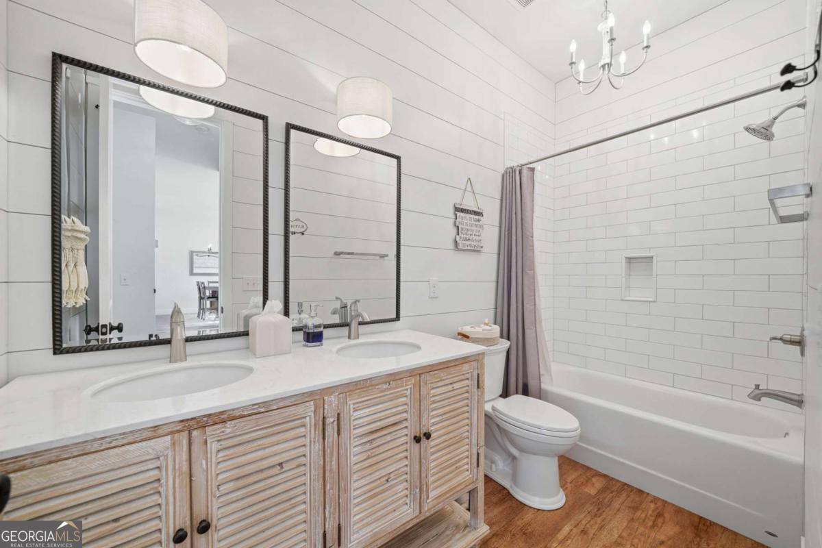 1950 Damascus Road Ball Ground, GA 30107 - Photo 17 of 29 a bathroom with a double vanity sink toilet mirror and bathtub