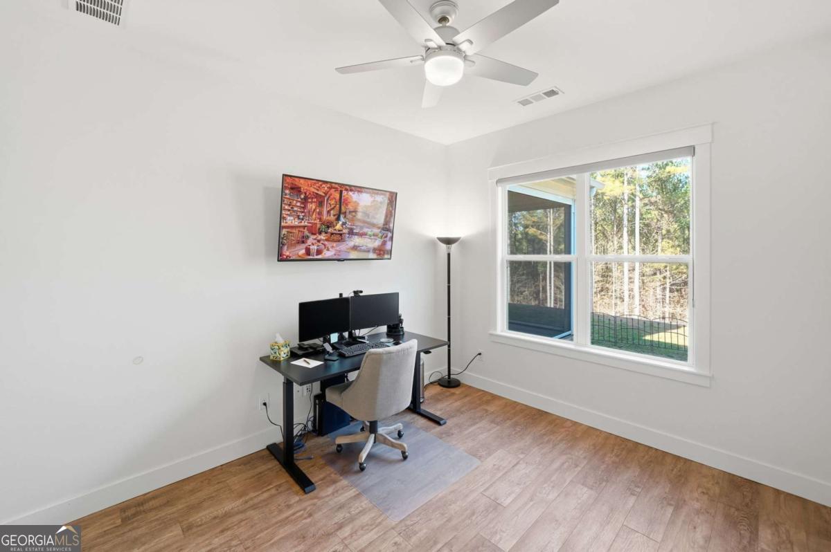 1950 Damascus Road Ball Ground, GA 30107 - Photo 19 of 29 a view of a workspace with furniture and a window