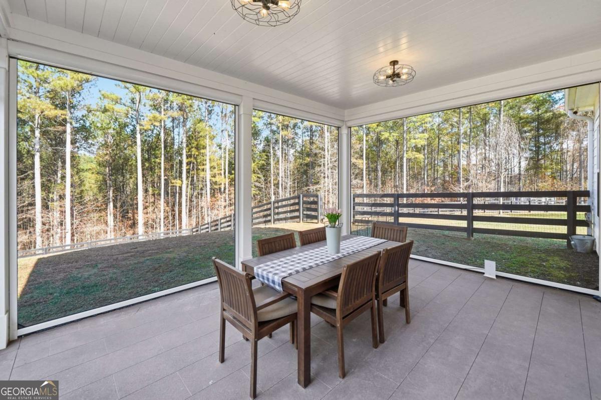 1950 Damascus Road Ball Ground, GA 30107 - Photo 20 of 29 a dining room with furniture and a floor to ceiling window