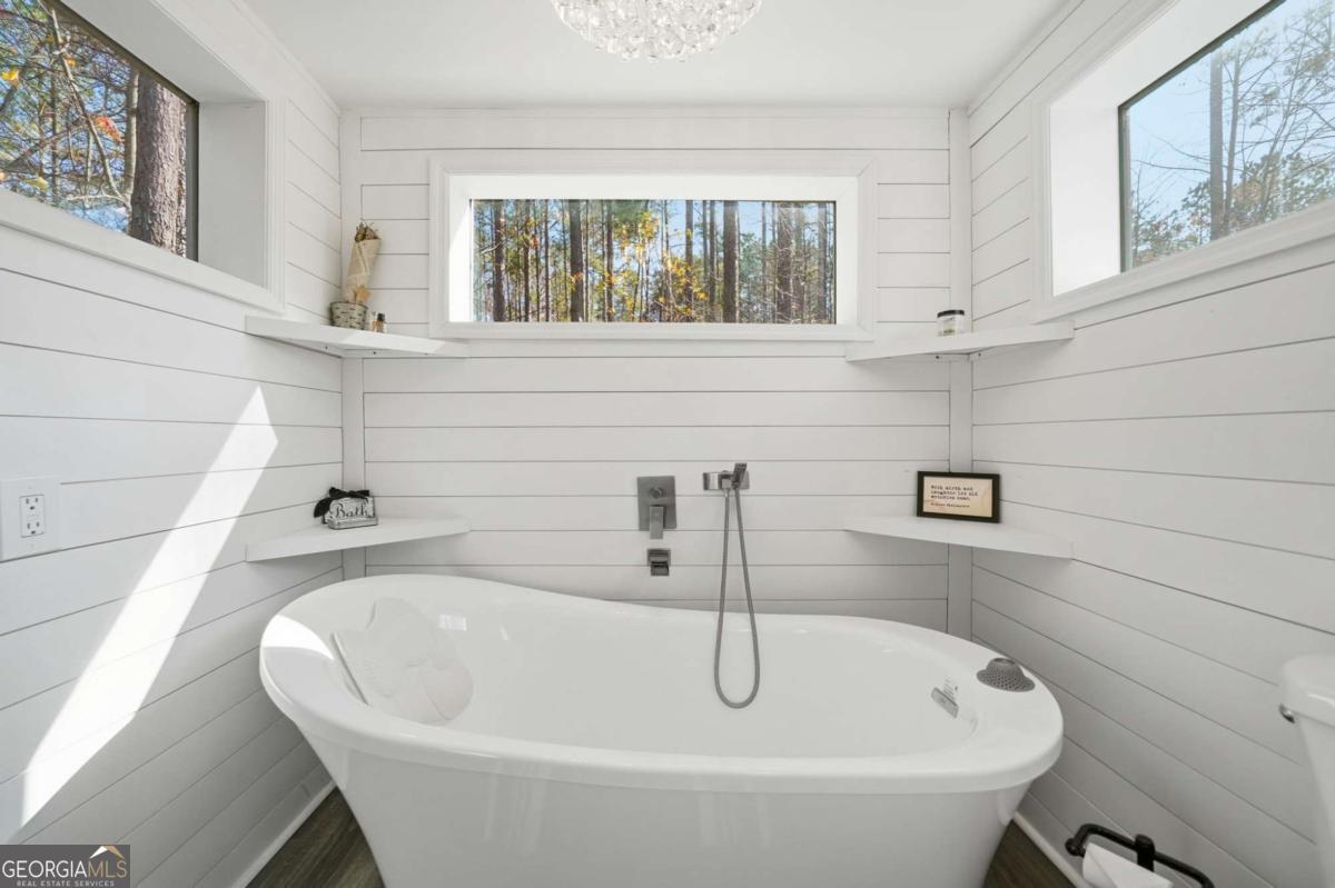 1950 Damascus Road Ball Ground, GA 30107 - Photo 25 of 29 a bathroom with bathtub and window