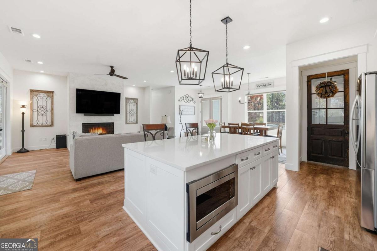 1950 Damascus Road Ball Ground, GA 30107 - Photo 10 of 29 a large kitchen with stainless steel appliances granite countertop a stove and a wooden floors