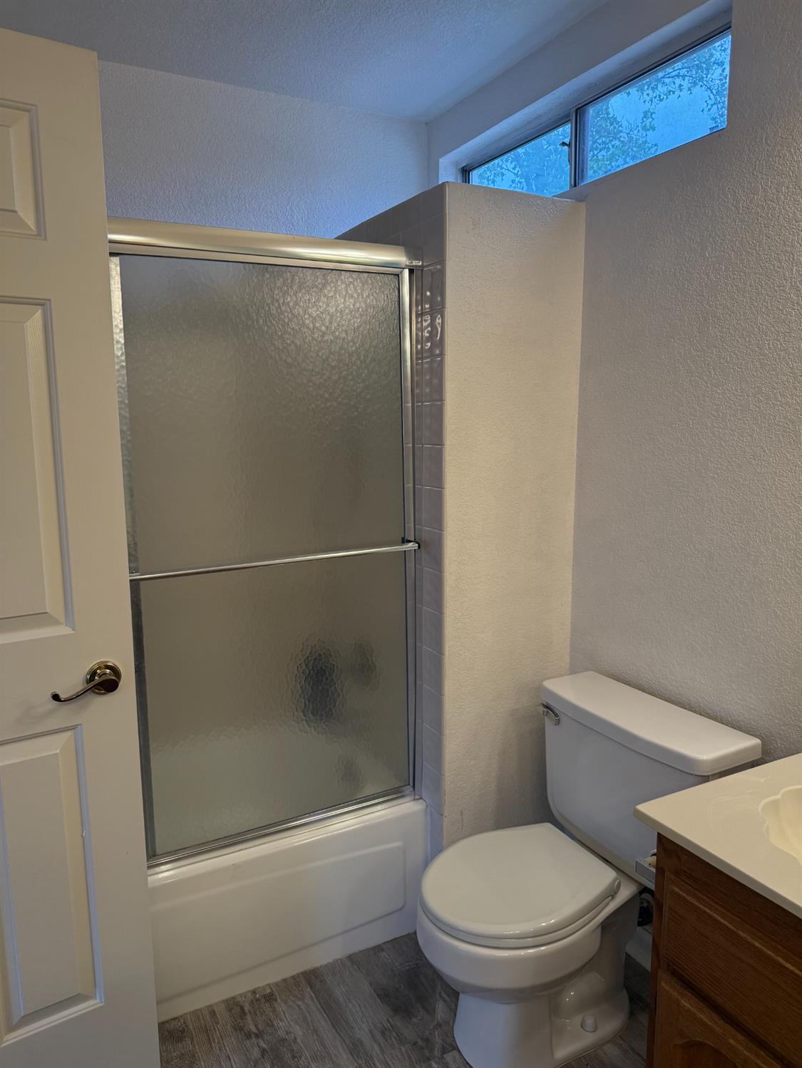 1004 Shasta Avenue Modesto, CA 95358 - Photo 24 of 37 a white toilet sitting next to a bath tub