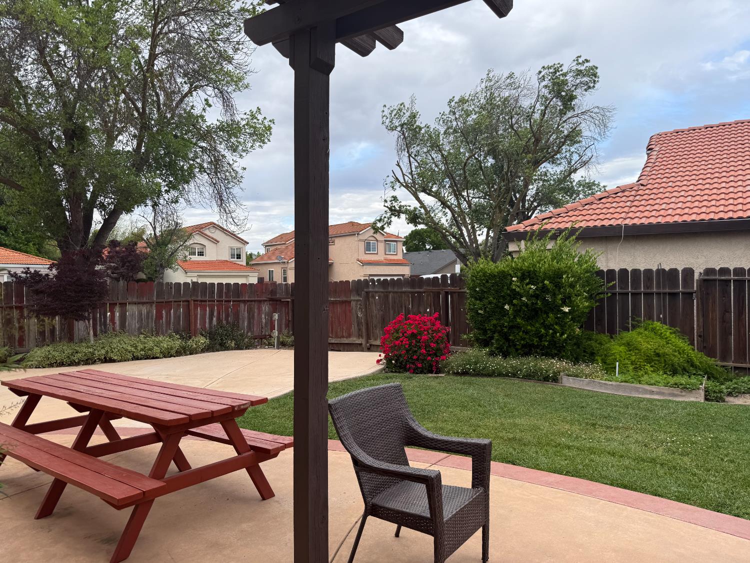 1004 Shasta Avenue Modesto, CA 95358 - Photo 34 of 37 a view of a patio with table and chairs and potted plants with wooden fence