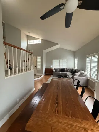 a living room with furniture and two window
