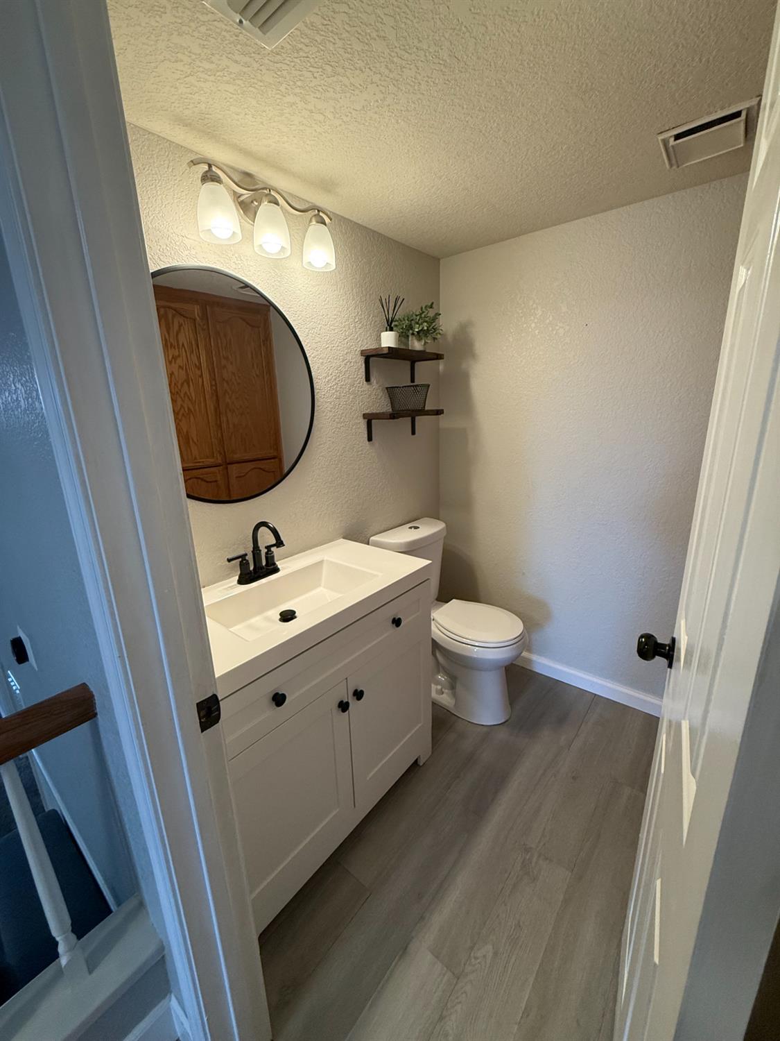 1004 Shasta Avenue Modesto, CA 95358 - Photo 10 of 37 a bathroom with a double vanity sink mirror and toilet