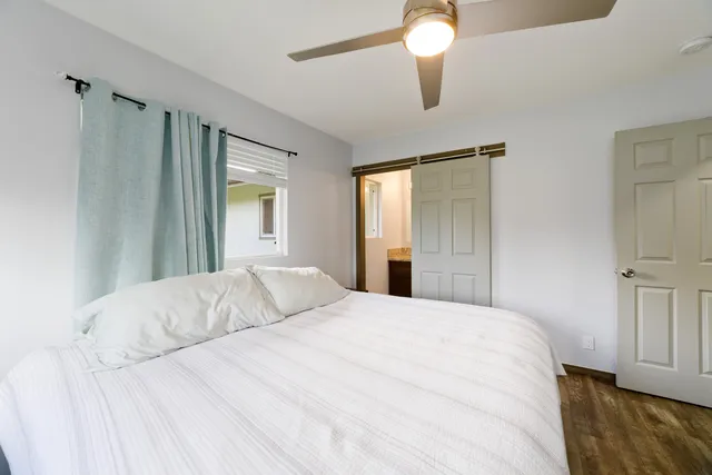 a bedroom with a bed and a chandelier