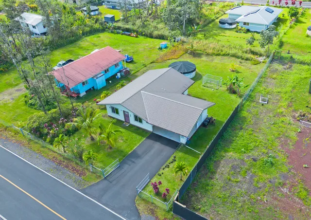 an aerial view of a house with yard swimming pool and outdoor seating