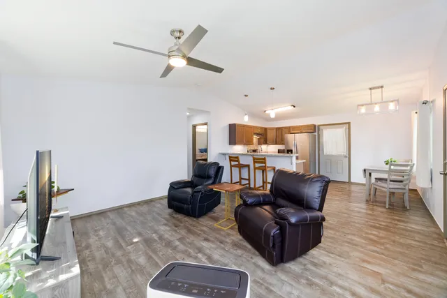 a living room with furniture and a wooden floor