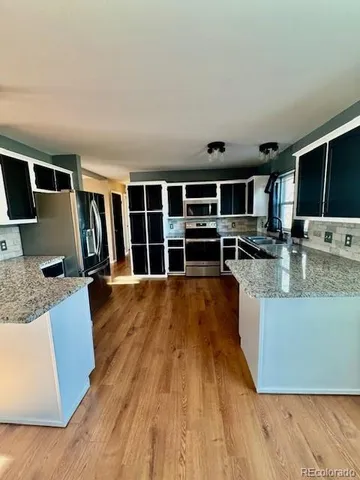a view of kitchen with wooden floor and windows