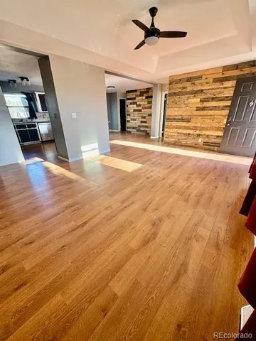 a view of an empty room with wooden floor
