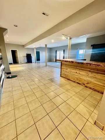 a bedroom with a large bed and a night stand