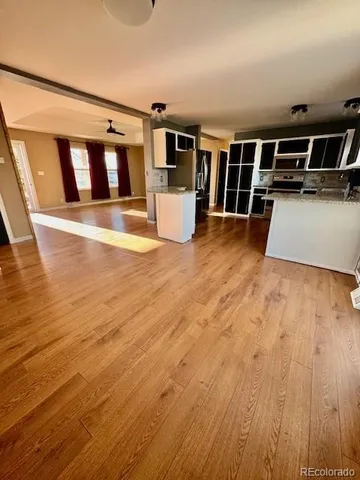 a view of a kitchen with wooden floor