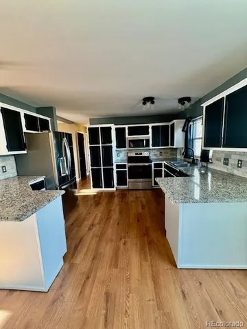 a view of kitchen with cabinets and wooden floor