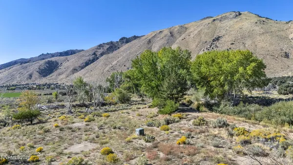 a view of a large mountain with a mountain in the background