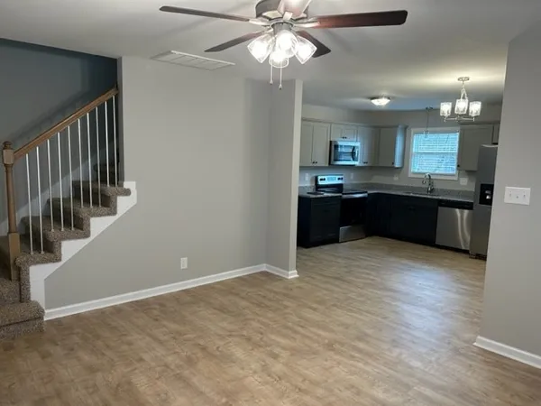 a large kitchen with kitchen island a stove a sink dishwasher and a refrigerator