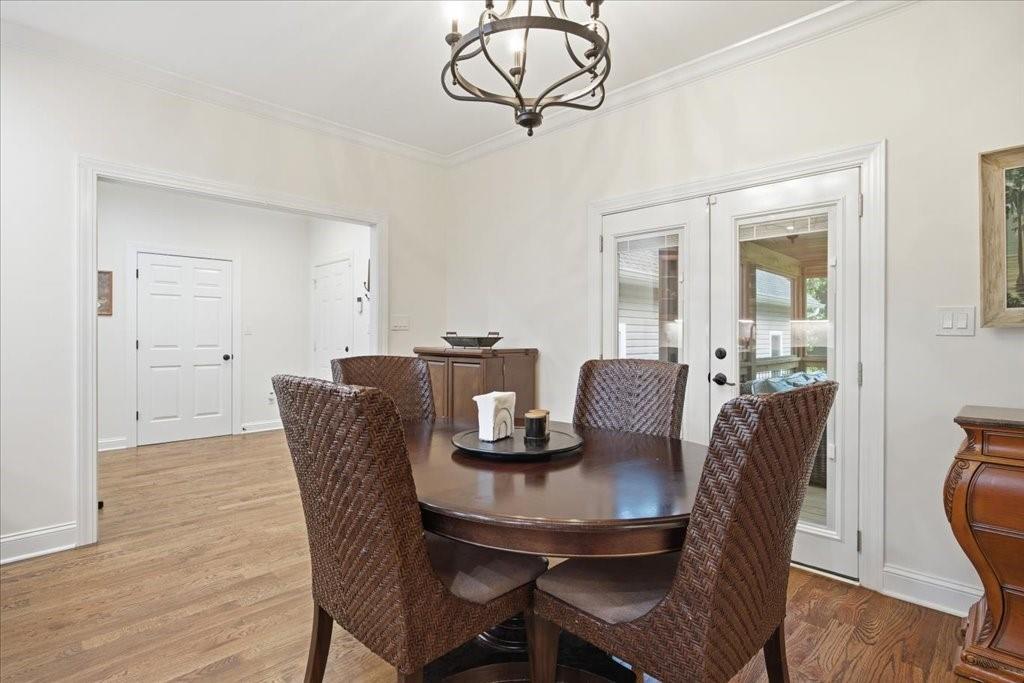 397 Thomas Road Dallas, GA 30132 - Photo 20 of 108 a dining room with furniture a chandelier and wooden floor
