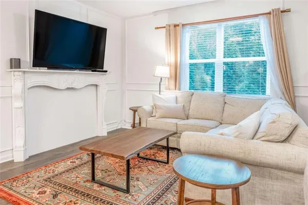 a living room with furniture and a flat screen tv