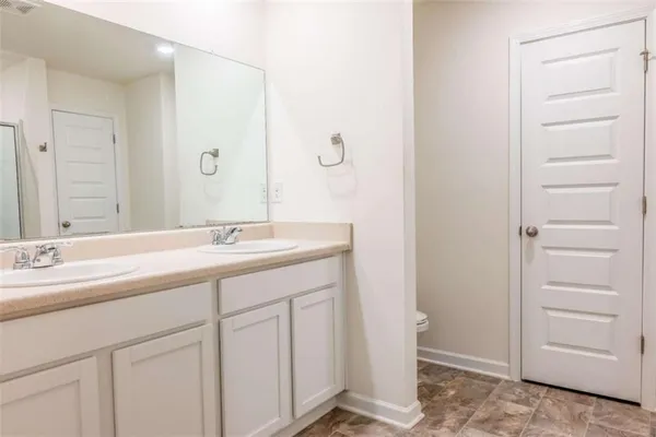 a bathroom with a double vanity sink and a mirror