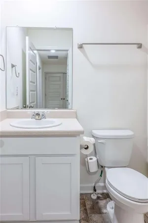 a bathroom with a sink a toilet and vanity