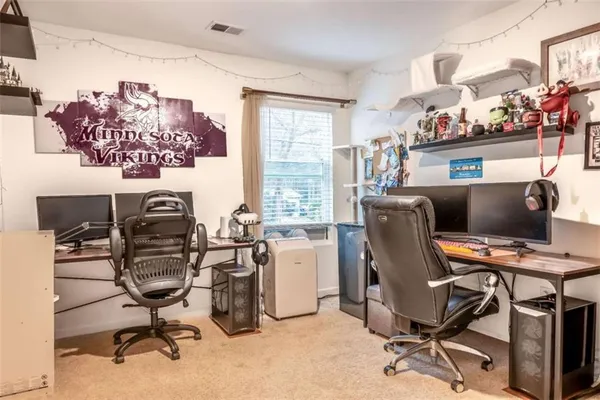 a view of a workspace with furniture and a window